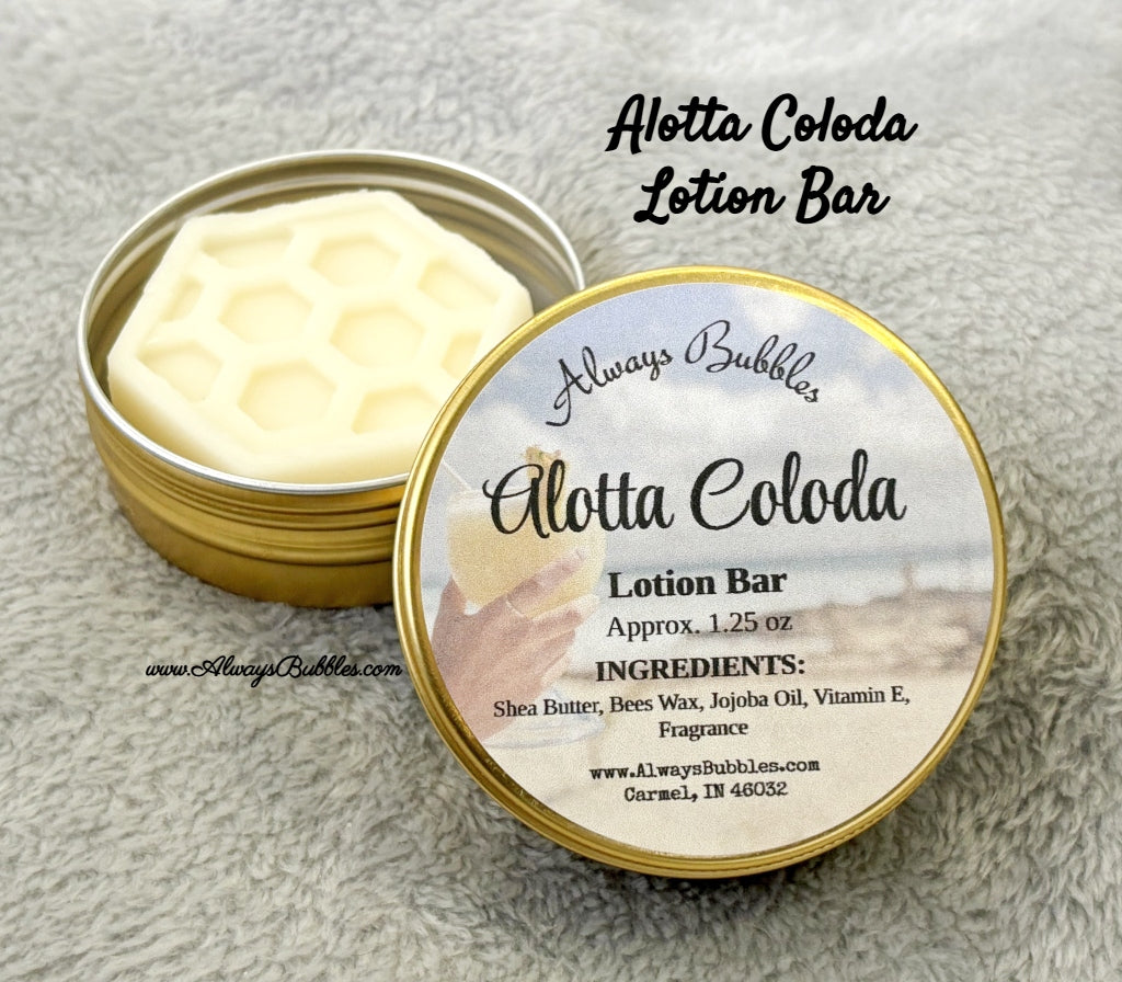 Always Bubbles Alotta Coloda Lotion Bar in a tin with label on a textured surface