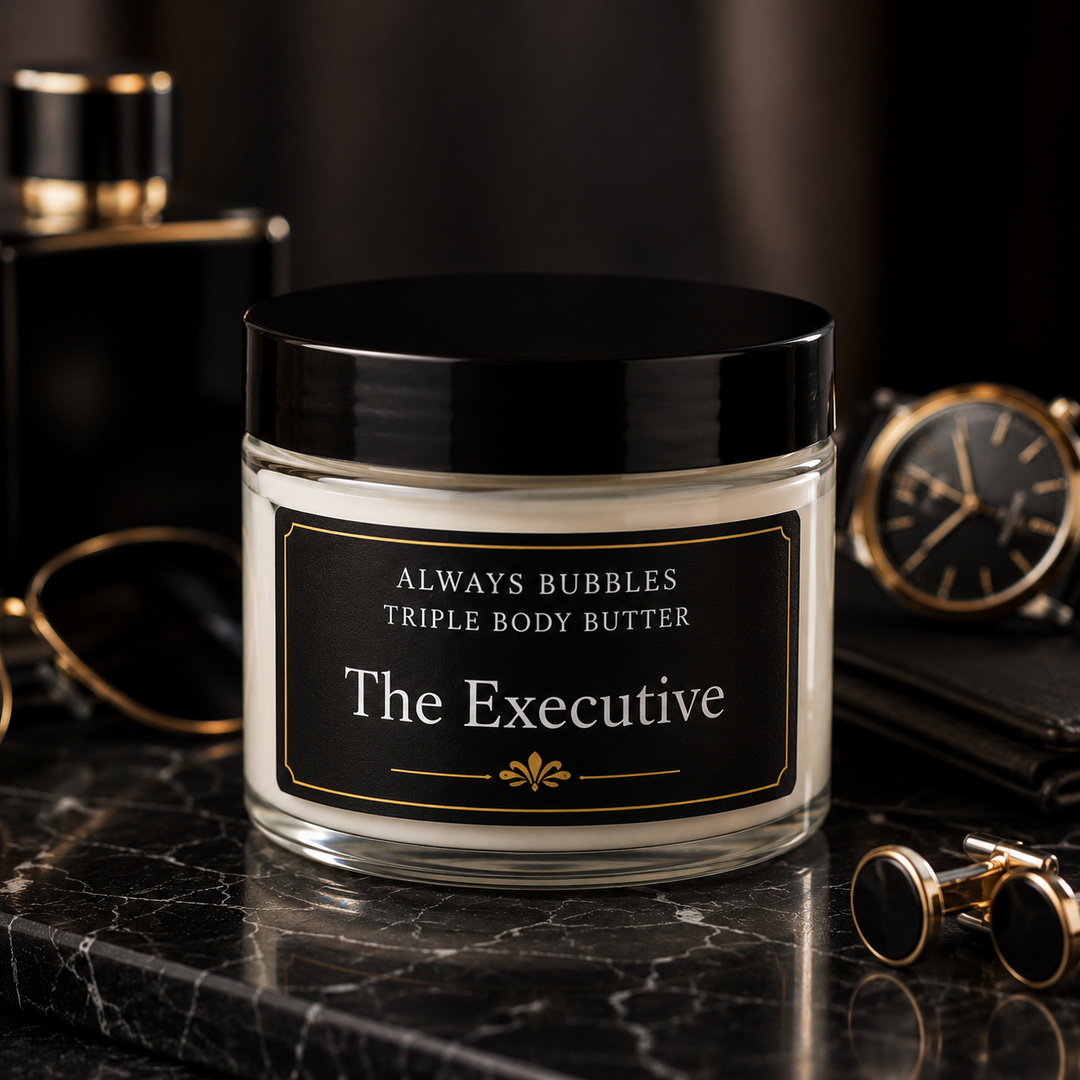 Always Bubbles The Executive Triple Body Butter in a clear jar with a black lid, displayed with luxury men's accessories on a black marble surface.