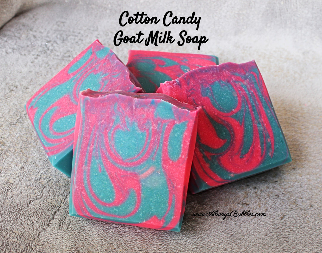 Always Bubbles Cotton candy goat milk soap with pink and blue swirls on a textured surface.
