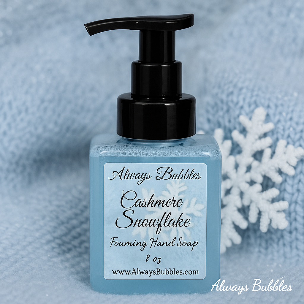 Always Bubbles Cashmere Snowflake Foaming Hand Soap in square clear bottle with soft icy blue soap and cozy winter knit snowflake background