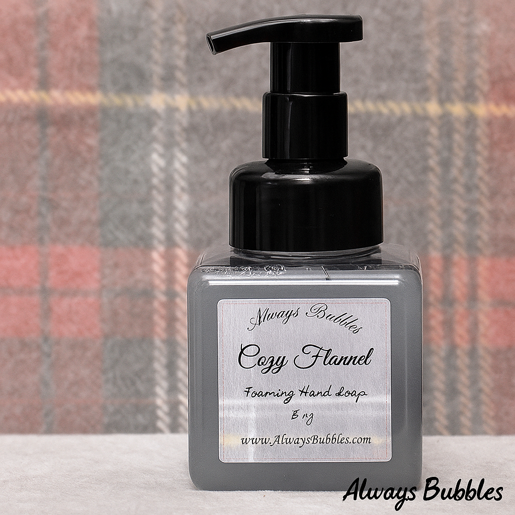 Always Bubbles Cozy Flannel Foaming Hand Soap in square clear bottle with gray soap and warm plaid flannel background