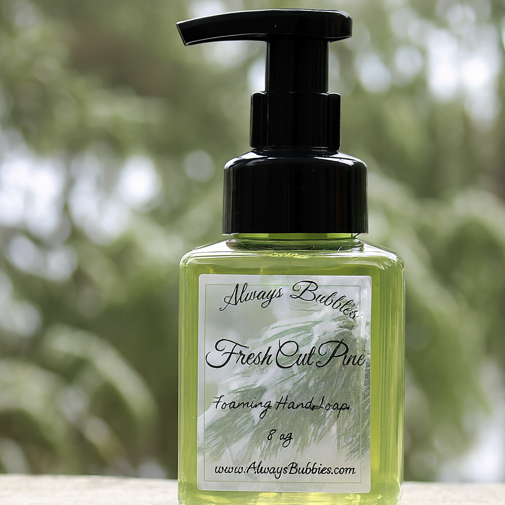 Always Bubbles Fresh Cut Pine Foaming Hand Soap in square clear bottle with green soap and crisp evergreen forest background