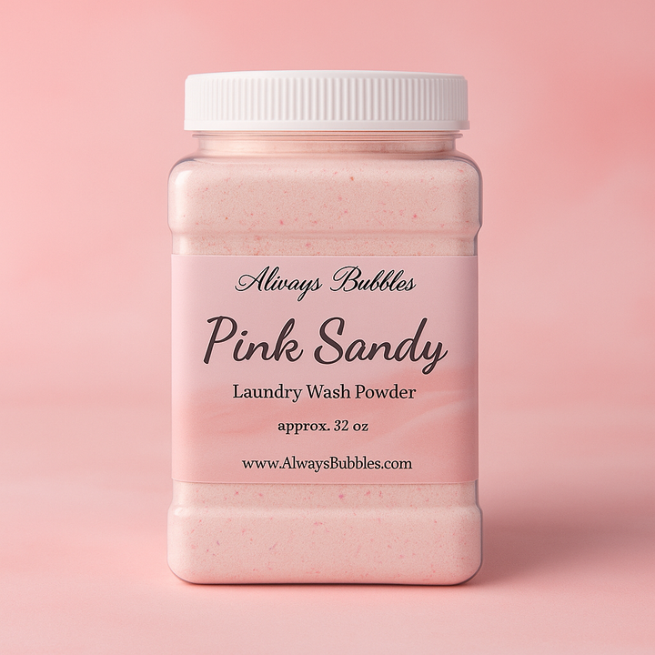 Always Bubbles Pink Sandy Laundry Wash Powder in a 32 oz jar with a soft pink background inspired by the Pink Sands scent