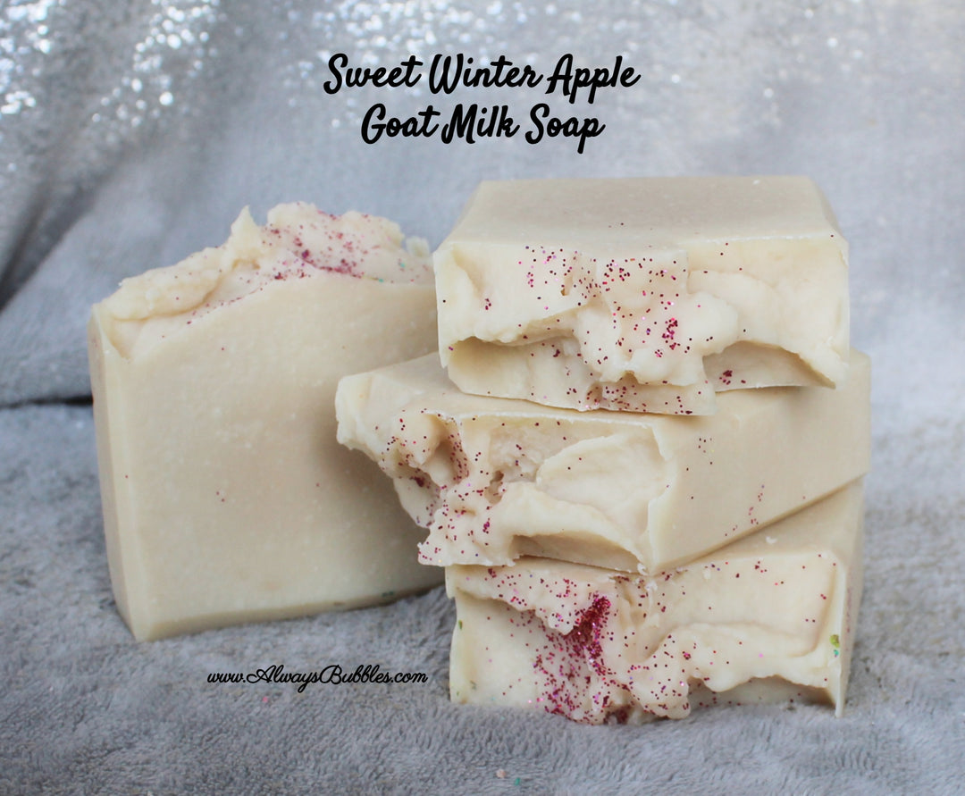 Sweet Winter Apple Goat Milk Soap by Always Bubbles — handmade natural soap with goat milk, shea butter, and nourishing oils. Cream-colored bar topped with a snowy swirl and dusted with red glitter sparkle. Fresh apple-inspired fragrance for winter skincare.